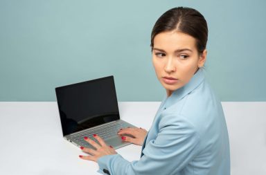 Worried looking woman at desk in front of computer